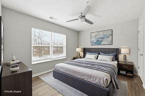 Columbus apartment for rent - A bedroom with a large bed and a ceiling fan.