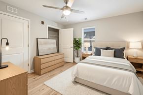 Hendersonville apartment for rent - A bedroom with a large bed and a ceiling fan.
