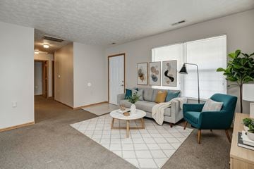 Weirton apartment for rent - A living room with a grey carpet and a white rug.