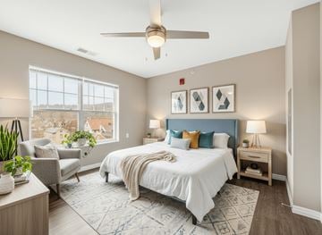 Wheeling apartment for rent - A bedroom with a large bed and a ceiling fan.