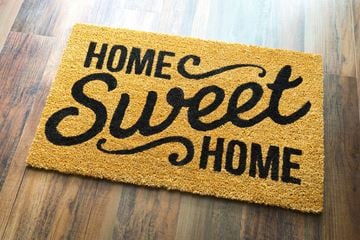 Parkersburg apartment for rent - A doormat that says "Home Sweet Home" on a wooden floor.