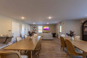 Lexington apartment for rent - A dining room with a long wooden table and chairs.