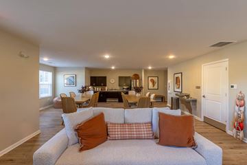 Lexington apartment for rent - A living room with a grey couch and orange pillows.