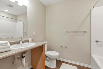Columbus apartment for rent - A white toilet sits in a bathroom next to a sink and a bathtub.