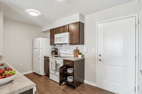 Johnston apartment for rent - A kitchen with white appliances and a white door.