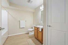 Athens apartment for rent - A bathroom with a toilet, sink, and mirror.