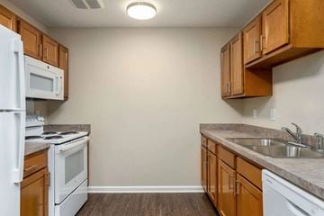 Wheeling apartment for rent - a kitchen with a stove microwave oven and sink