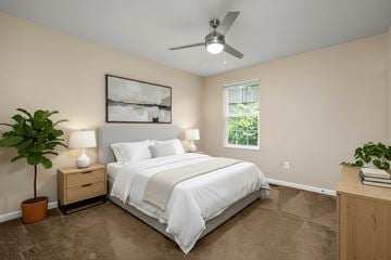 Wheeling apartment for rent - A bedroom with a bed, nightstand, and a ceiling fan.