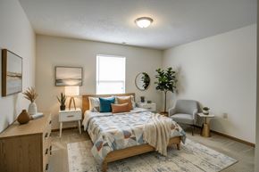 Clyde apartment for rent - A bedroom with a bed, nightstand, and chair.