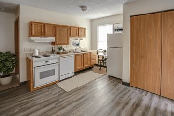 Clyde apartment for rent - A kitchen with wooden cabinets and a white fridge.