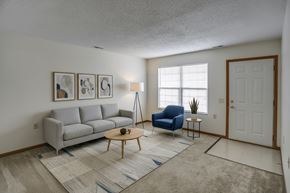 Clyde apartment for rent - A living room with a grey couch, blue chair, and a coffee table.