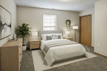 Fremont apartment for rent - A bedroom with a large bed, nightstands, and a potted plant.