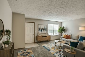 Fremont apartment for rent - A living room with a couch, a rug, and a painting on the wall.