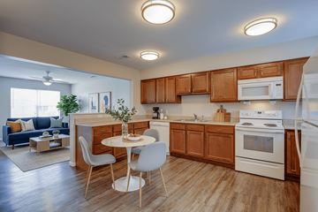 Rock Creek apartment for rent - A kitchen with wooden cabinets and white appliances.