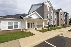 Zanesville apartment for rent - A large apartment complex with multiple buildings and a driveway in front.