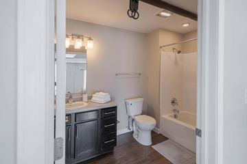 Nelsonville apartment for rent - A bathroom with a white toilet and a white sink.