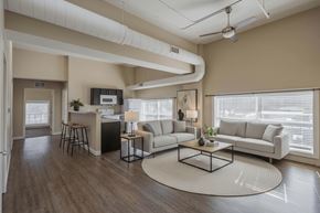 Nelsonville apartment for rent - A living room with a white couch, a black coffee table, and a rug on the floor.