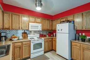 Summerville apartment for rent - A kitchen with wooden cabinets and a white refrigerator.