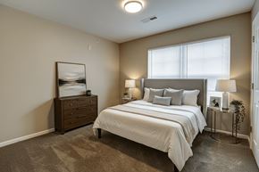 Linden apartment for rent - A bedroom with a bed, nightstand, and lamp.