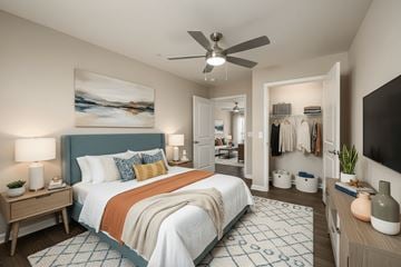 Wheeling apartment for rent - A bedroom with a large bed and a ceiling fan.