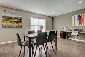 New Bern apartment for rent - a dining room with a table and chairs and a desk with a computer