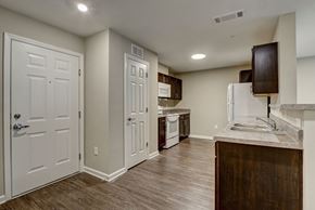 New Bern apartment for rent - A kitchen with white cabinets and a white refrigerator.