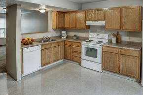 Stambaugh apartment for rent - A kitchen with wooden cabinets and white appliances.