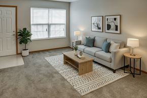 Stambaugh apartment for rent - A living room with a couch, a coffee table, and two lamps.
