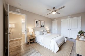 Wilson apartment for rent - A bedroom with a large bed and a ceiling fan.