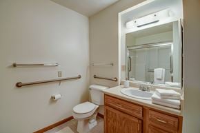Wheeling apartment for rent - A white toilet sits next to a sink in a bathroom.