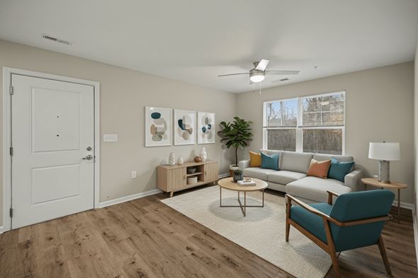 Cherryville apartment for rent - A living room with a blue chair and a white door.