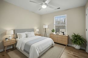 Cherryville apartment for rent - A bedroom with a bed, nightstands, and a plant.