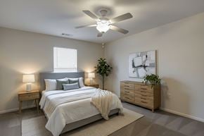 Saluda apartment for rent - A bedroom with a bed, nightstands, and a ceiling fan.