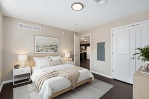 Grand Rapids apartment for rent - A bedroom with a large bed and a painting on the wall.