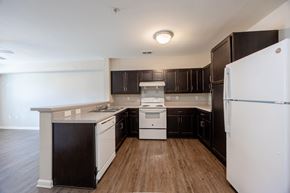 Zebulon apartment for rent - A kitchen with black cabinets and white appliances.