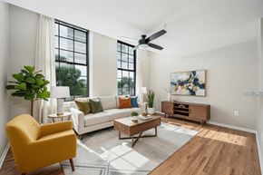 Columbus apartment for rent - A living room with a yellow chair, a white couch, and a wooden coffee table.