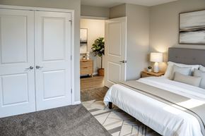 Eminence apartment for rent - A bedroom with a large bed and a mirror on the wall.