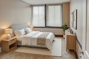 Washington Court House apartment for rent - A bedroom with a large bed and a nightstand with a lamp.