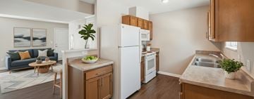 Pontiac apartment for rent - A kitchen with a white refrigerator and wooden cabinets.