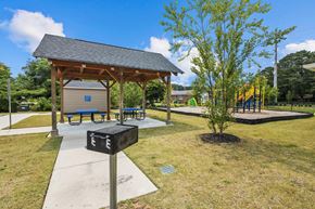 Greenville apartment for rent - a picnic pavilion with benches and a playground in a park