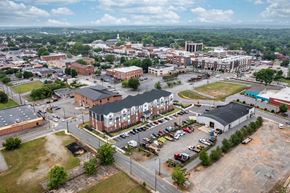 Hickory apartment for rent - an aerial view of a city with a parking lot and buildings
