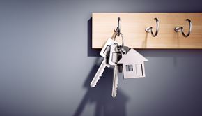 Chambersburg apartment for rent - A set of keys is hanging from a hook on a wooden board with the word "home" written on it.