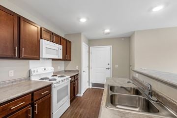 Springettsbury Twp apartment for rent - an empty kitchen with white appliances and wooden cabinets