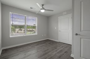 Columbia apartment for rent - an empty bedroom with a large window and a ceiling fan