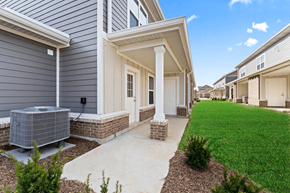 Noblesville apartment for rent - a walkway leading to a house with a yard and a cooling unit