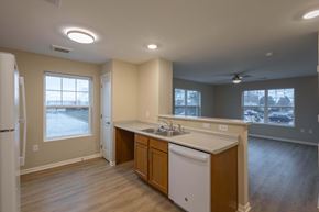 Columbus apartment for rent - A kitchen with wooden cabinets and a white dishwasher.