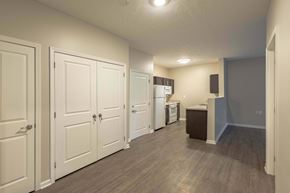 Athens apartment for rent - A kitchen area with white cabinets and a refrigerator.