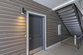 Lancaster apartment for rent - A dark grey door is on the left side of a staircase.