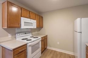 Lancaster apartment for rent - A kitchen with a white stove and a white microwave.