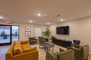 Columbus apartment for rent - A living room with a yellow couch and a flat screen TV.